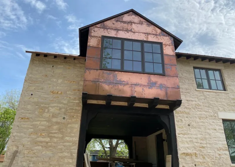 Copper metal panel facade on a stone building for Skylight Installation in Big Stone Gap