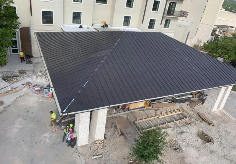 Metal roofing installation team working on a commercial building in Big Stone Gap